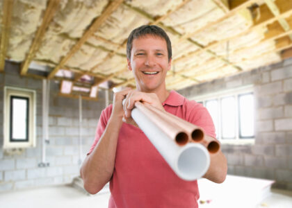 Picture of a plumber holding Uponor Pex pipes