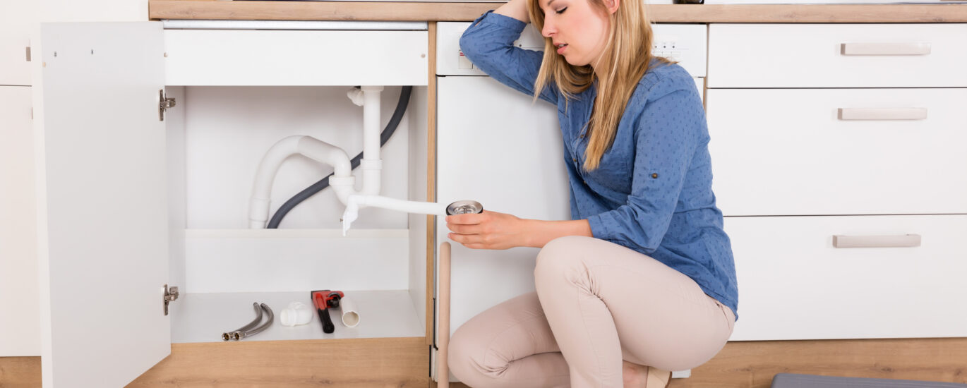 frustated women experiencing plumbing system maintenance mistakes