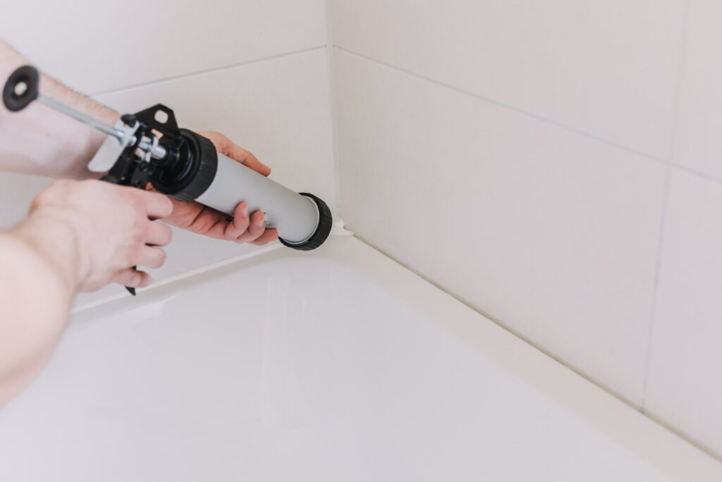 Plumber finishing bath tub installation