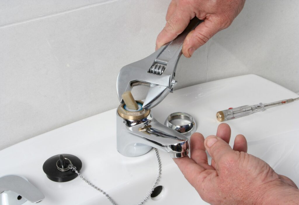 Sink installation and repair being performed by plumber