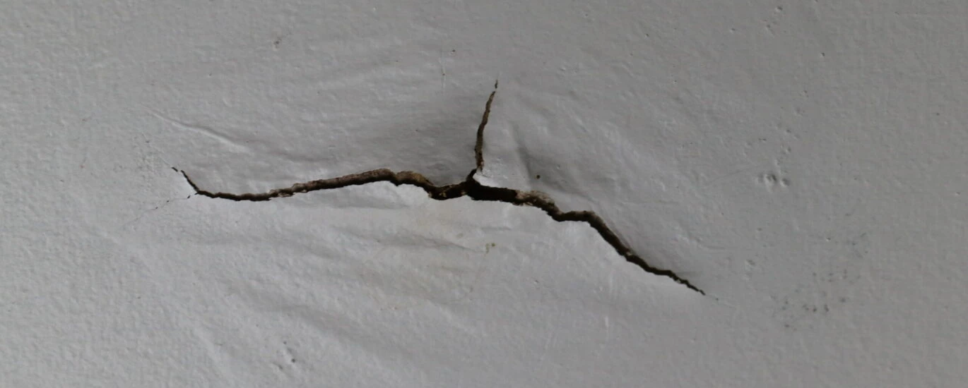 Ceiling water damage and cracked paint.