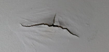 Ceiling water damage and cracked paint.