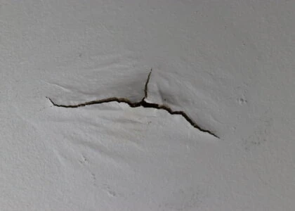 Ceiling water damage and cracked paint.